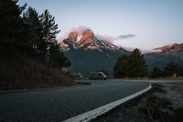 Scenic view of road with parked van against mountain peak