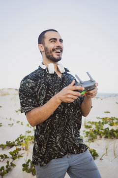 Young Man having fun with a drone controller in hands. 
