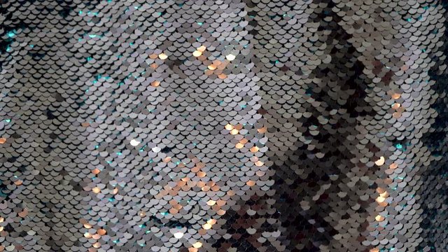 Seamless loop background silver sequin fabric with sparkling gold light