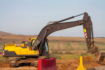 A large iron excavator at the construction site