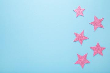Fototapeta na wymiar Pink glittering star on pink background, top view
