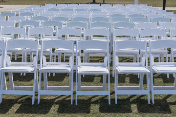 Empty Rows of White Chairs
