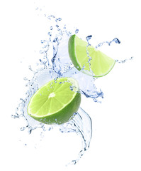 Ripe limes and splashing water on white background