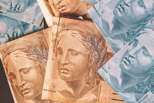 Brazilian Real - BRL. Currency, Money, Dinheiro, Brasil. Several Brazilian Real banknotes on a table. One hundred and fifty reais notes.
