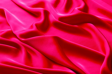 Pink color silk fabric background, top view