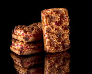 Cookies with raspberry jam on a black background with reflection