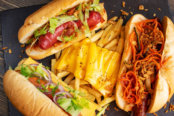 three hot dogs with fries