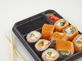 California rolls in a disposable container, fast food.Isolate white background