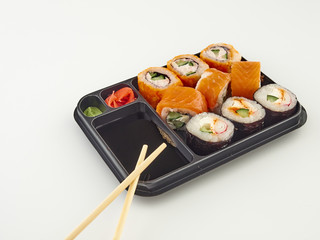 California rolls in a disposable container, fast food.Isolate white background