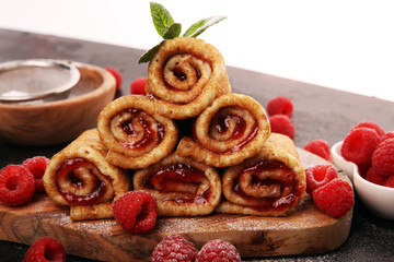 Delicious Tasty Homemade crepes or pancakes with raspberries and mint on rustic background