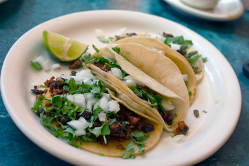 tacos al pastor served on restaurant table