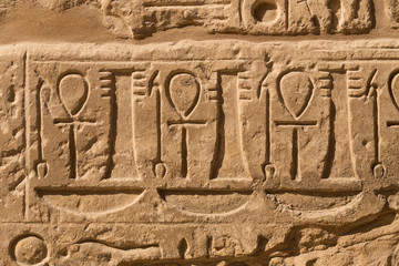 Karnak Temple, complex of Amun-Re. Embossed hieroglyphics on walls. Luxor Governorate, Egypt. Ankh is an ancient Egyptian hieroglyphic symbol that means the word 