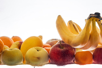 Ripe fruit under water. Vegetarianism, healthy eating. Fruit on a white background.
