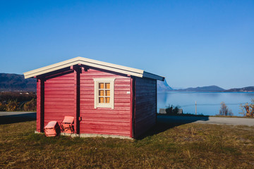 View of Classical Norwegian Camping site with traditional wooden red cottages, Northern Norway