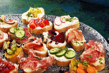 Assorted bruschetta with various toppings. Appetizing bruschetta or brie crostini. Variety of small sandwiches. Mix bruschetta on table