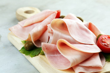 Sliced ham on wooden background. Fresh prosciutto cotto. Tasty Pork ham sliced