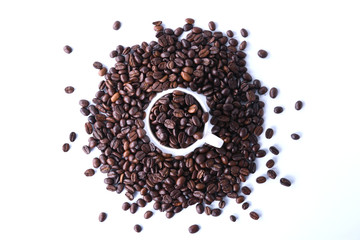 Coffee beans and cup of coffee isolated on white background