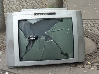 Old television with a broken screen
