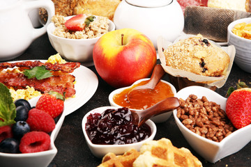 Breakfast served with coffee, orange juice, croissants, cereals and fruits. Balanced diet. Continental breakfast with granola and fruits