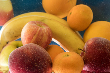 lot of fresh fruit splashing in fresh water