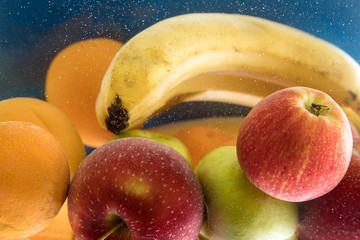 lot of fresh fruit splashing in fresh water