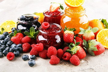 assortment of jams, seasonal berries jelly, mint and fruits and tangerine