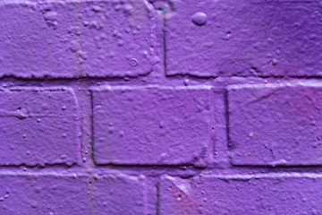 Background: Bricks spray-painted with purple paint