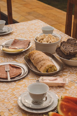 Composed table with afternoon coffee and white crockery, homemade ingredients and comforting food