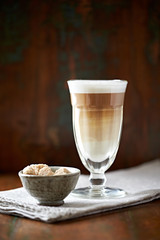 Caffe latte on brown background. Front view.