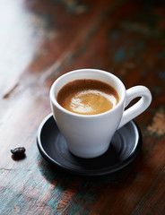 Cup of coffee on rustic wooden background