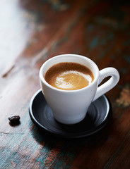 Cup of coffee on rustic wooden background