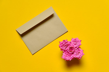 Proposal kit with kraft envelop on plain yellow background