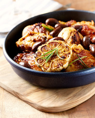 Grilled chicken pieces with kalamata olives and fresh rosemary.