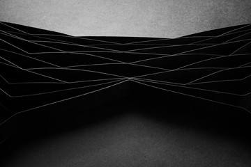 Abstract minimalist curve lines seamless modern architecture pattern made of black folded paper