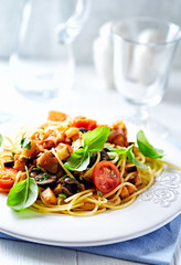 Spaghetti pasta with vegetable sauce. Bright background