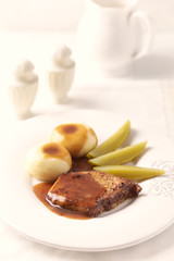 Fried Pork Steak with potato dumplings. Bright background.