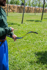 Archer in traditional clothes shooting an arrow