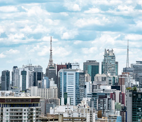 View of a big populous city with tall high density buildings, antennas on top the buildings. Photo taken at Bela Vista neighborhood, central region of São Paulo SP Brazil.