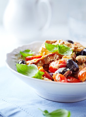 Penne pasta with fried pork tenderloin, cherry tomatoes and black olives.