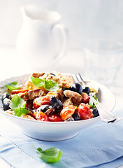 Penne pasta with fried pork tenderloin, cherry tomatoes and black olives.