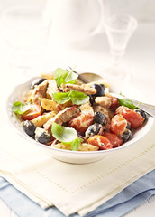 Penne pasta with fried pork tenderloin, cherry tomatoes and black olives.