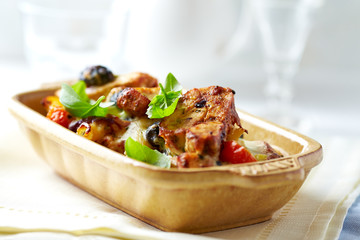 Penne pasta with fried pork tenderloin, cherry tomatoes and black olives. Oven baked.