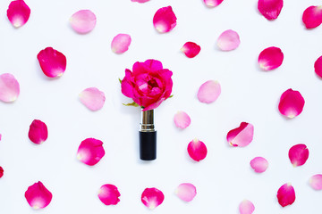 Fototapeta na wymiar Lipstick with rose petals isolated on white
