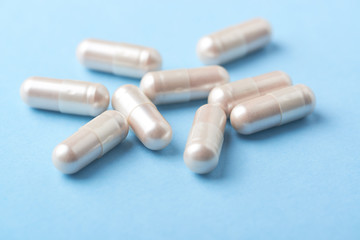 Carnitine capsules. Concept for a healthy dietary supplementation. Bright paper background. Soft focus. Close up.