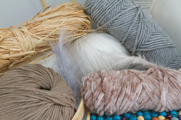 Balls of yarn, wool, rope and beads of earth blue and white colors.