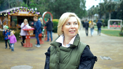 beautiful stylish trendy blond woman walking in a city Park in autumn