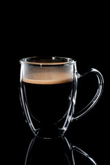 black coffee in a glass transparent cup on a black background