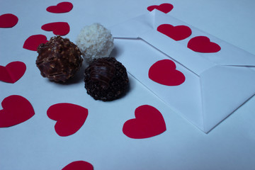 Card, chocolates and red hearts
