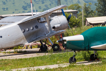 Novonezhino, Russia - Old helicopter rotor plane on a green airfield. Old rustic airfield with propeller aircraft.
