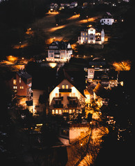 German village on the hill at night. Light at the house